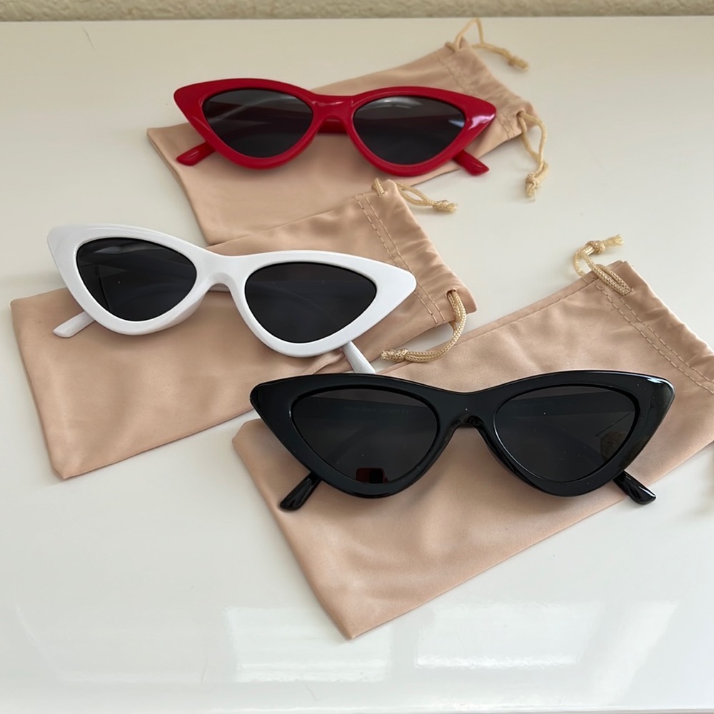 Trio of black, red, and white cat eye sunglasses